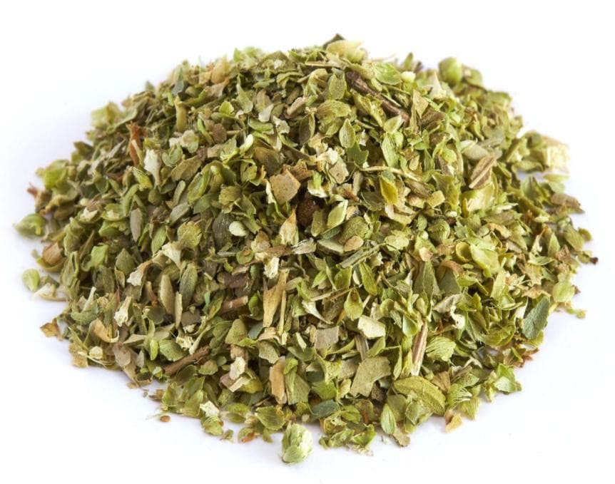 Pile of dried oregano flakes on a white background