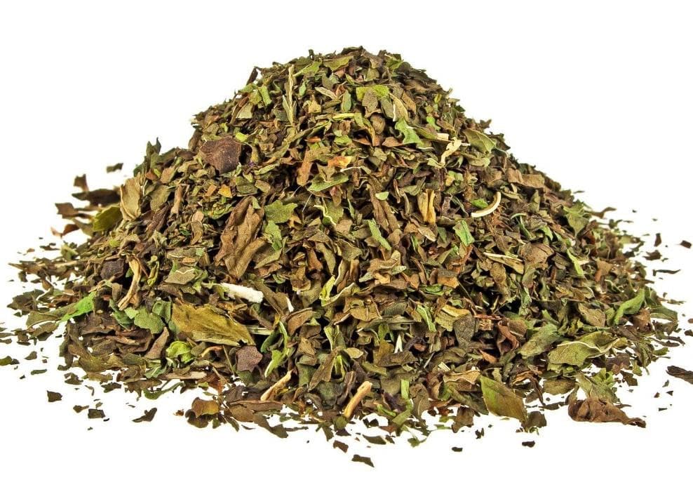 Pile of dried peppermint leaves on a white background