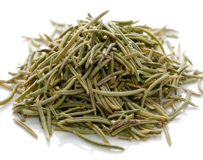 Pile of dried rosemary needles on a white background